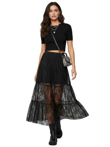 Woman wearing a black top and black lace skirt with a white background